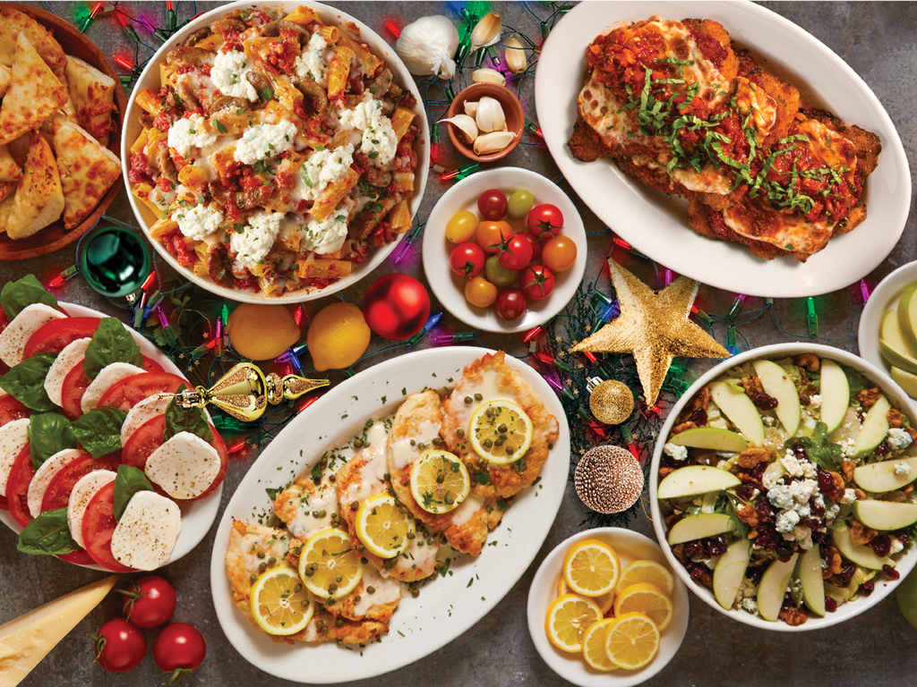 A spread of group dining food with holiday decor from Buca di Beppo