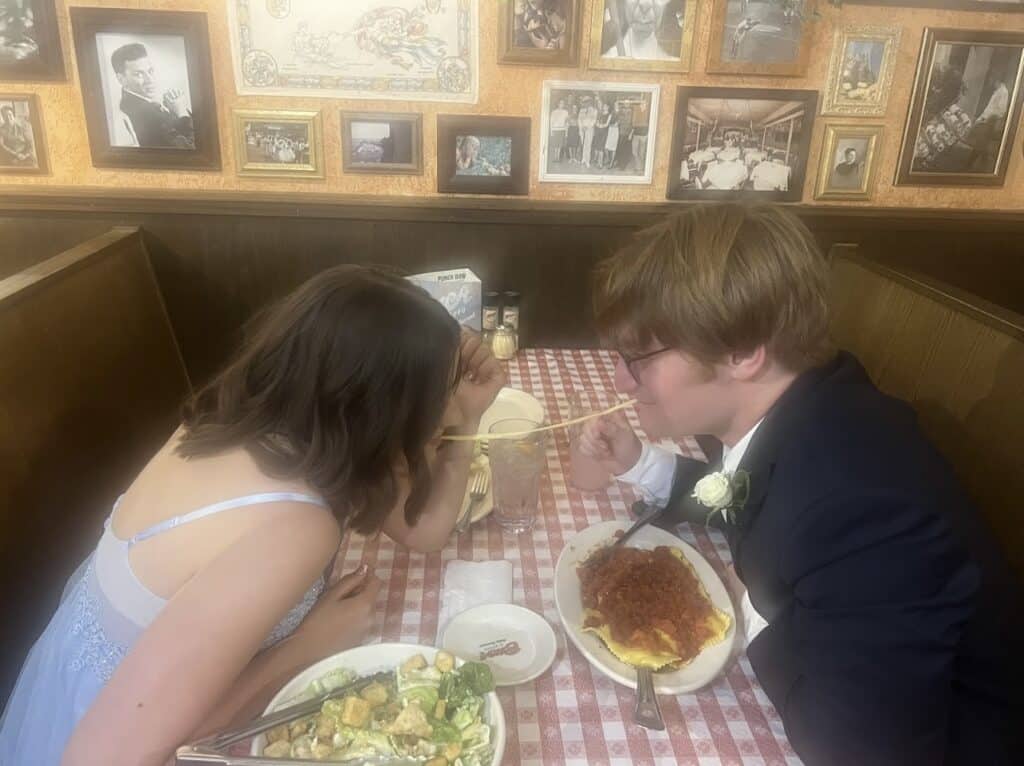 A young couple dressed up taking the pasta challenge