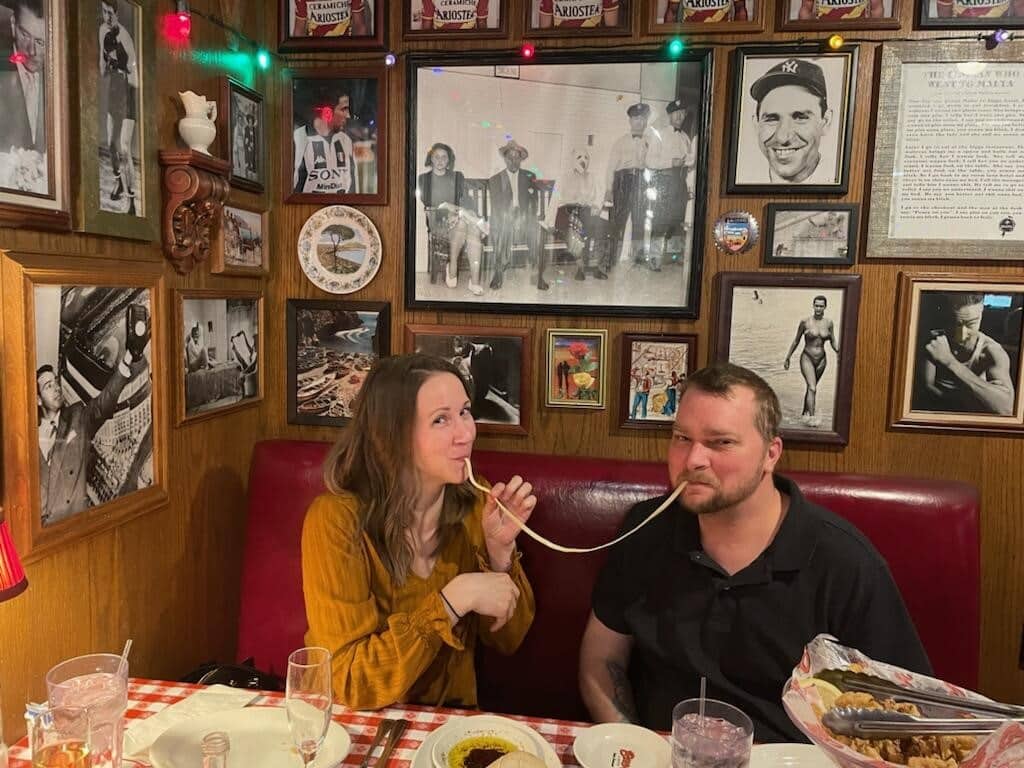 A couple sharing a noodle at Buca di Beppo