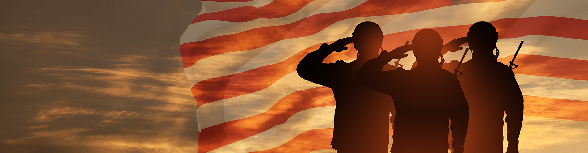 Silhouettes of soldiers in front of an American flag
